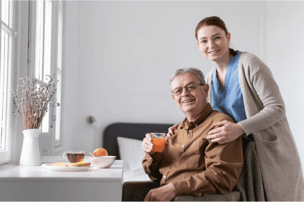 A happy patient at home with a caring nurse